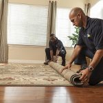 Man rolling up a carpet
